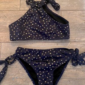 The halter's high neck trim with star cut-outs, and the bottom has side ties